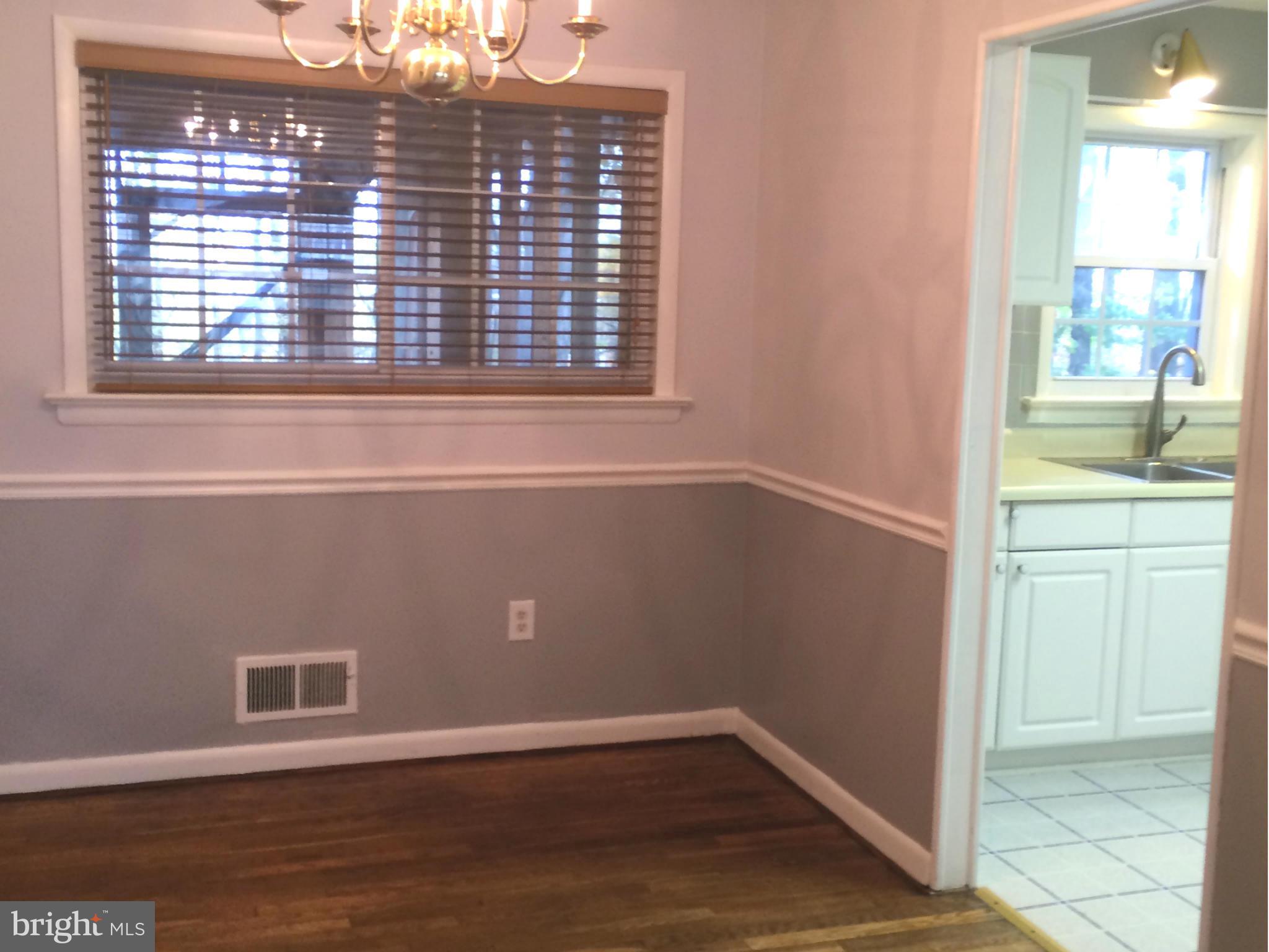 6814 Mayo Court Springfield, VA 22150 - Photo 21 of 30 a view of an empty room with wooden floor and a window