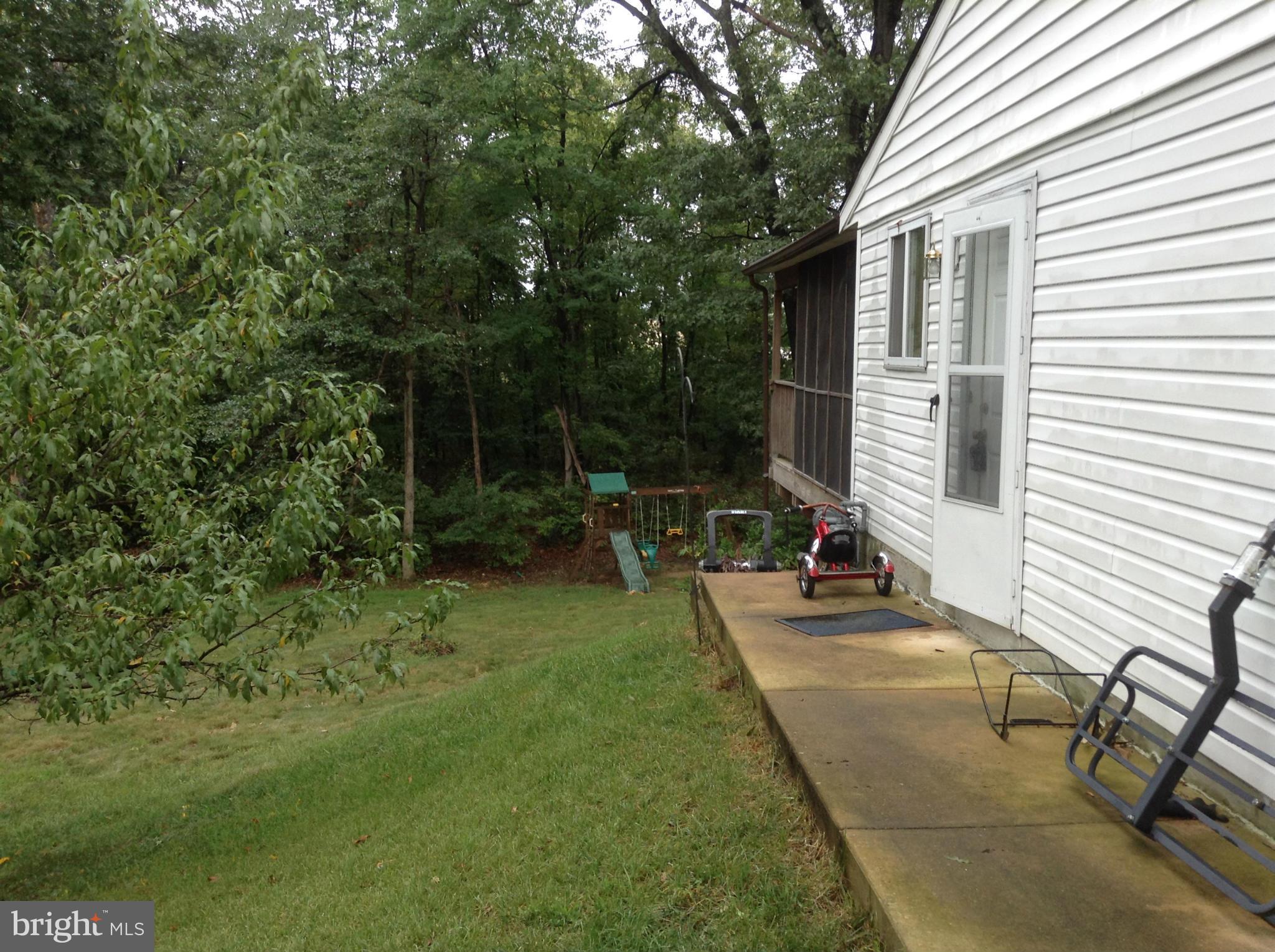 6814 Mayo Court Springfield, VA 22150 - Photo 10 of 30 a view of a backyard with sitting area and tree