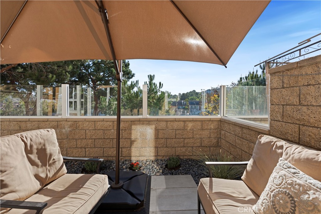 33 Gauguin Circle Aliso Viejo, CA 92656 - Photo 18 of 49 a view of a chair and tables in the patio