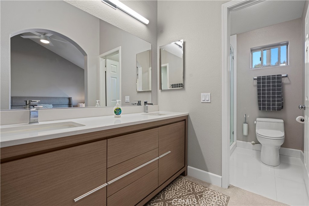 33 Gauguin Circle Aliso Viejo, CA 92656 - Photo 25 of 49 a bathroom with a double vanity sink a toilet and a mirror