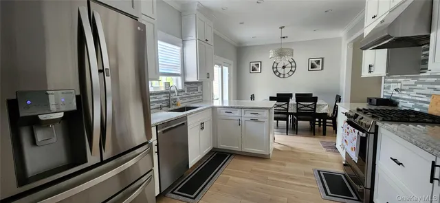 a kitchen with a sink stainless steel appliances and cabinets