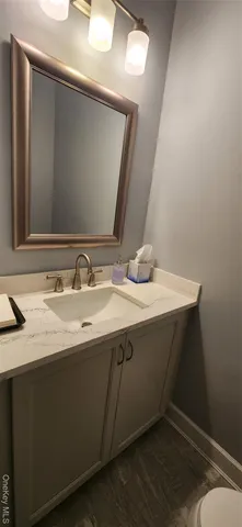 a bathroom with a toilet and a mirror