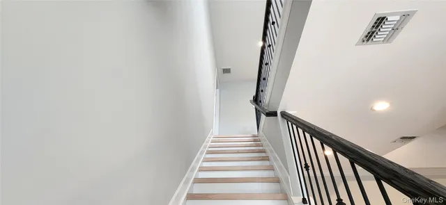 a view of stairs and hall with wooden floor