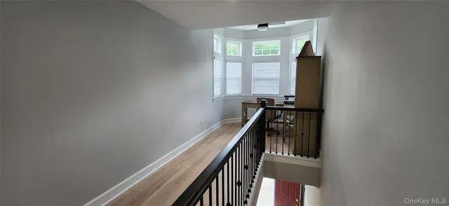 a view of a workspace with furniture and windows