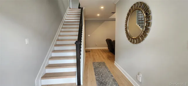 a view of entryway and hall with wooden floor