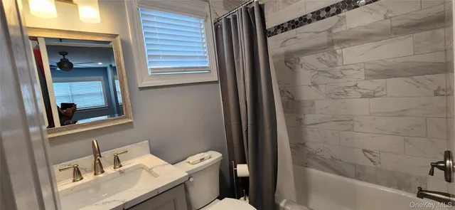 a white toilet sitting next to a bathroom sink