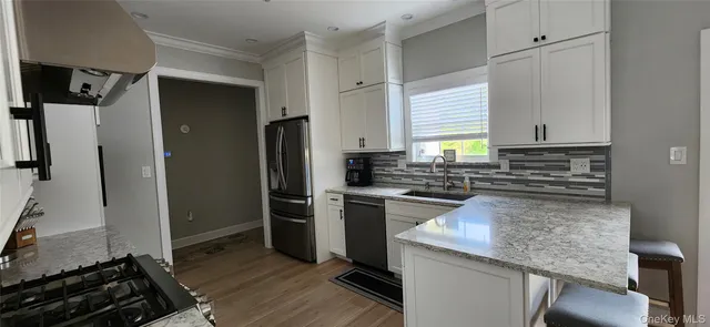 a kitchen with white cabinets and white appliances