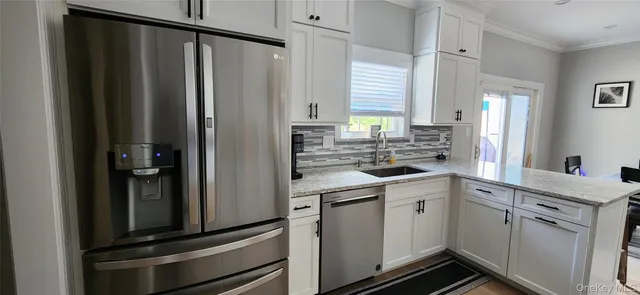 a kitchen with stainless steel appliances granite countertop a refrigerator stove and sink