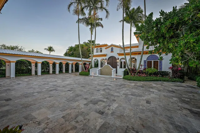 a front view of house with a garden