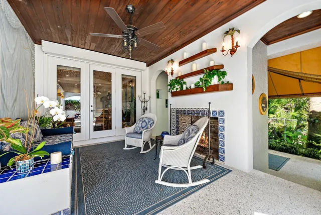a view of a patio with table and chairs and potted plants