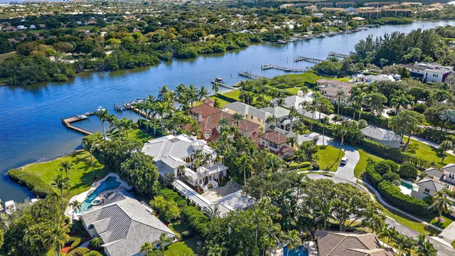 an aerial view of a house with a yard and lake view