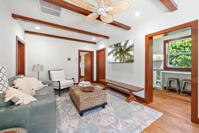 a kitchen with a stove a refrigerator and furniture