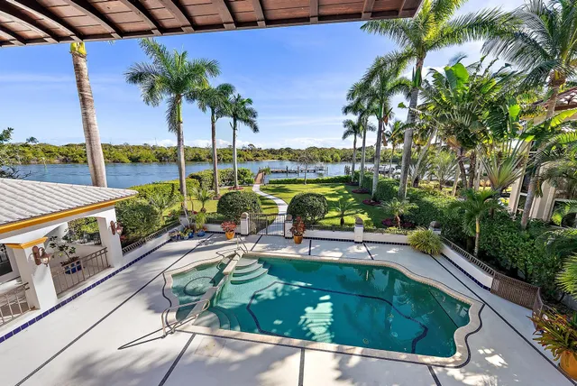 a view of a swimming pool with a patio and a garden