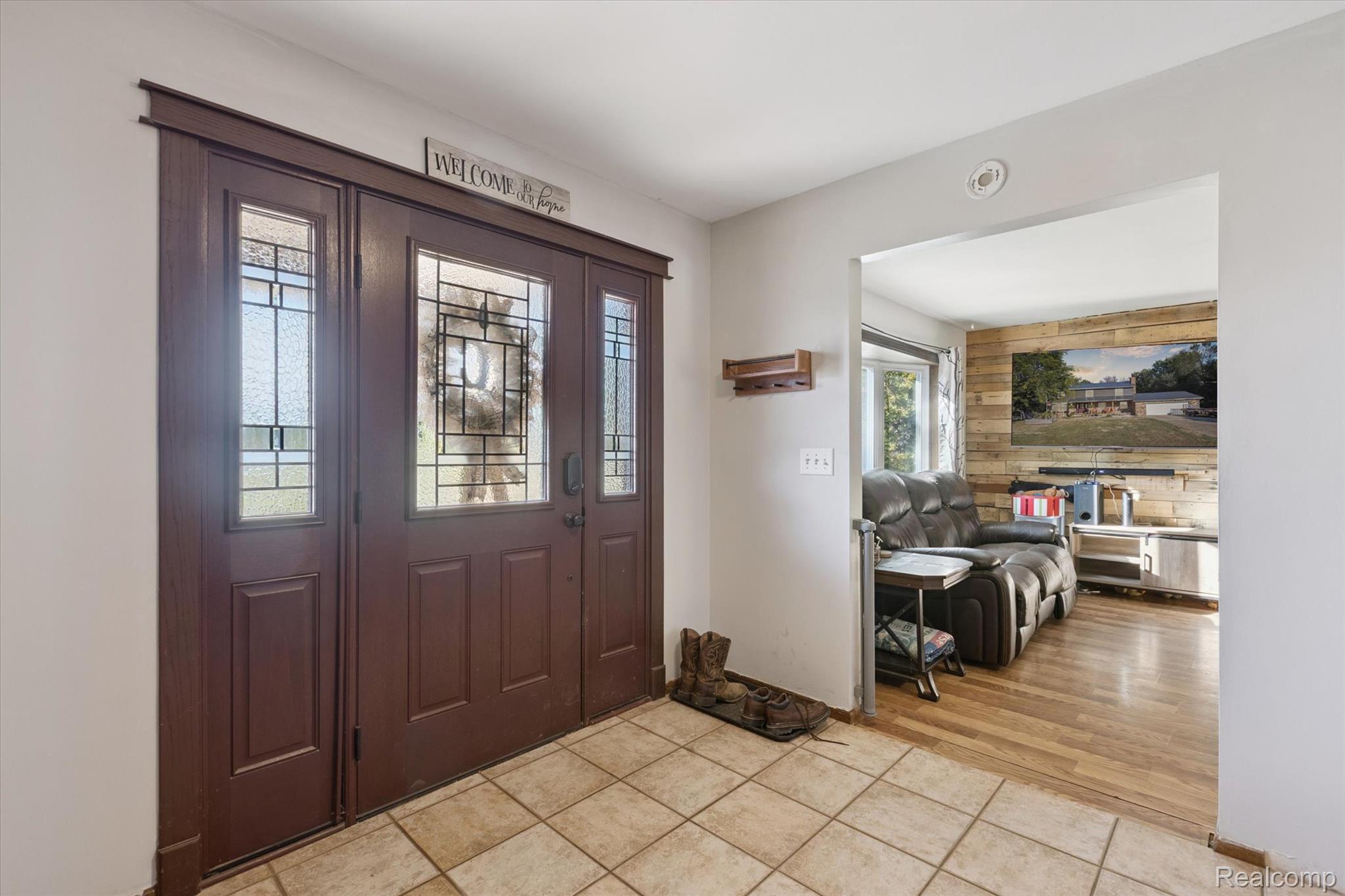 10147 South Bray Road Clio, MI 48420 - Photo 6 of 57 Foyer with wood walls and light tile patterned floors