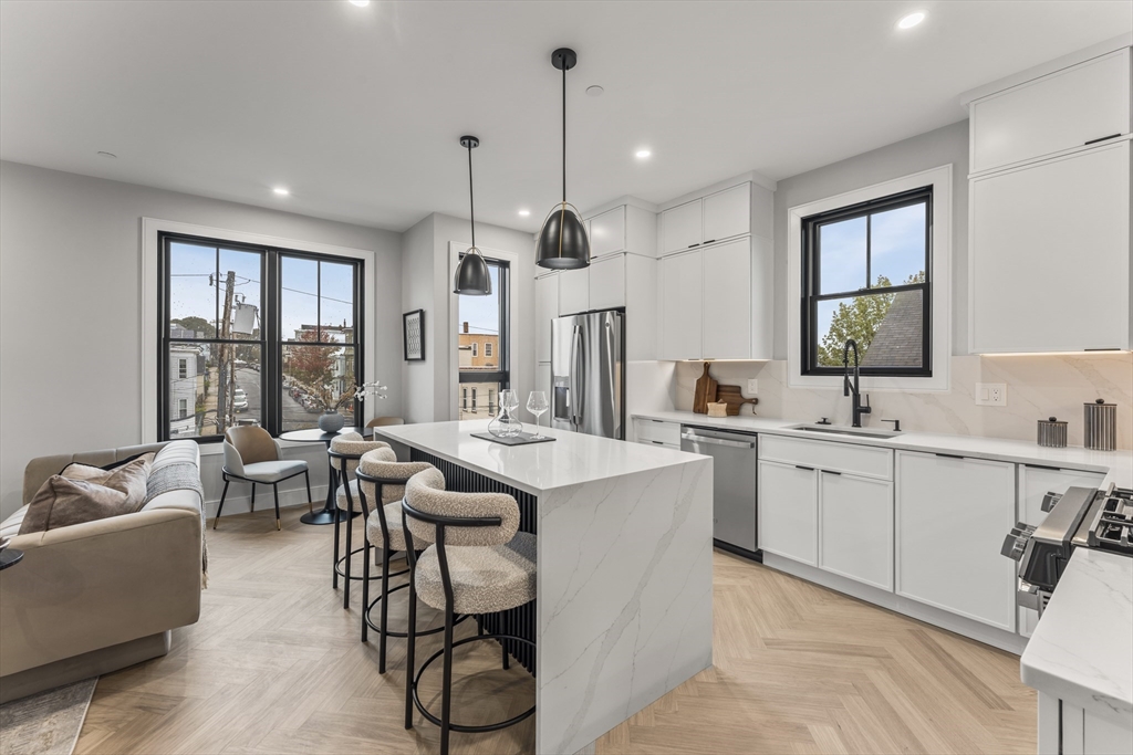106 Moore Street, Unit 8 Boston, MA 02128 - Photo 2 of 9 a large living room with a large window