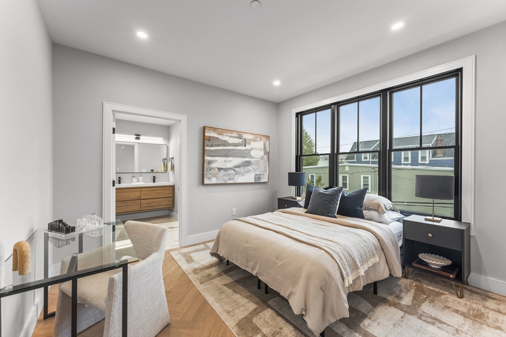 106 Moore Street, Unit 8 Boston, MA 02128 - Photo 4 of 9 a bedroom with a bed and wooden floor