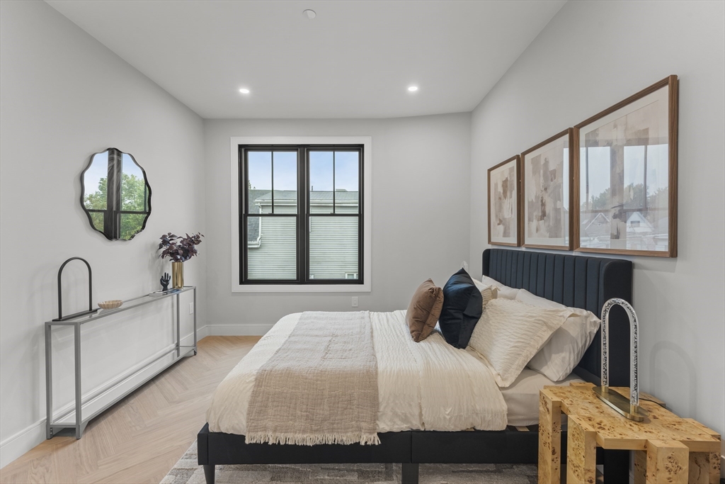 106 Moore Street, Unit 8 Boston, MA 02128 - Photo 6 of 9 a bedroom with a bed and a large window