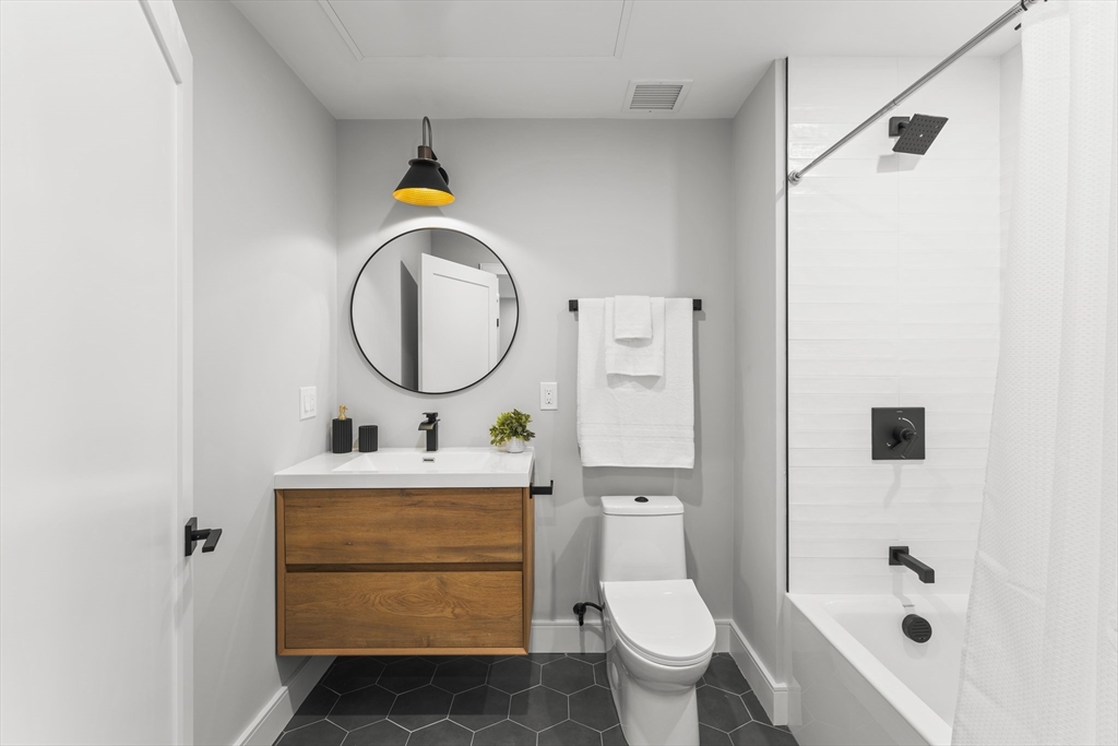 106 Moore Street, Unit 8 Boston, MA 02128 - Photo 7 of 9 a bathroom with a sink toilet and shower