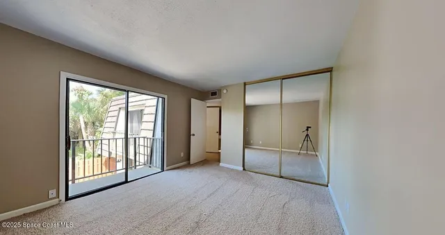 an empty room with windows and closet