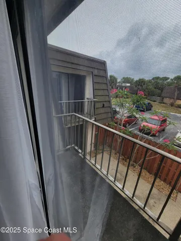 a view of a balcony with an outdoor seating