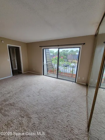 a view of an empty room and workspace
