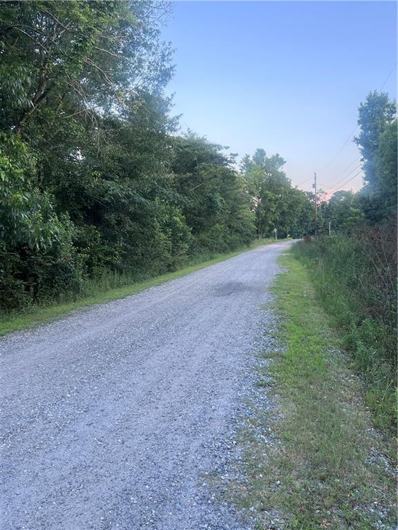 7070 Sofkee Place Macon, GA 31216 - Photo 2 of 8 a view of a field with trees in the background