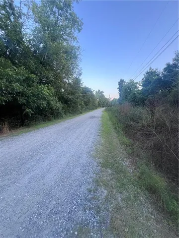 a view of a field with trees in background