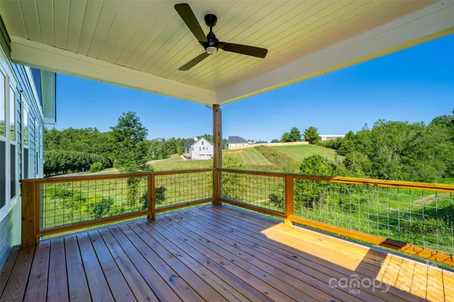 a view of a chairs and table on the wooden deck