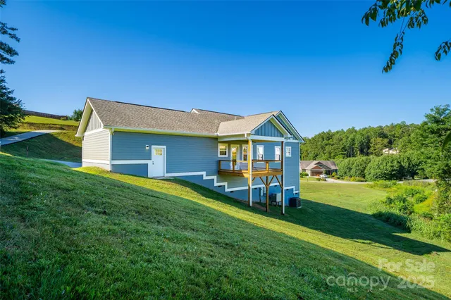 a view of house with backyard