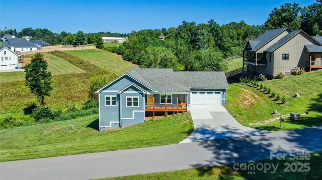 an aerial view of a house with yard and green space