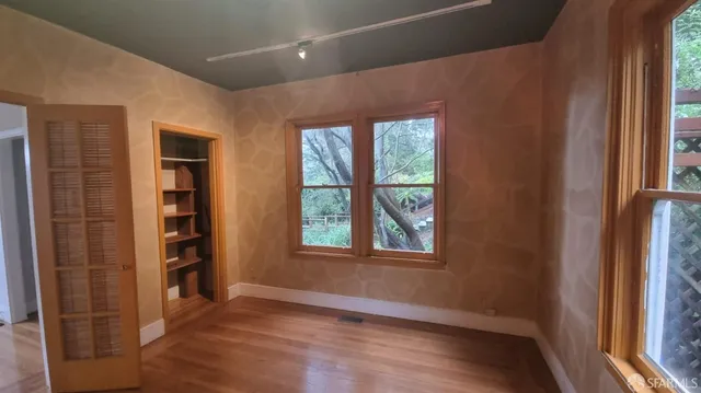 a view of balcony with wooden floor and outdoor seating
