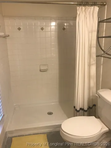 a view of a room with a ceiling fan