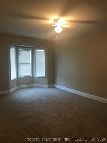 a white toilet sitting next to a bath tub and a shower