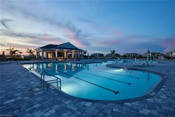 a view of a swimming pool with a table and chairs
