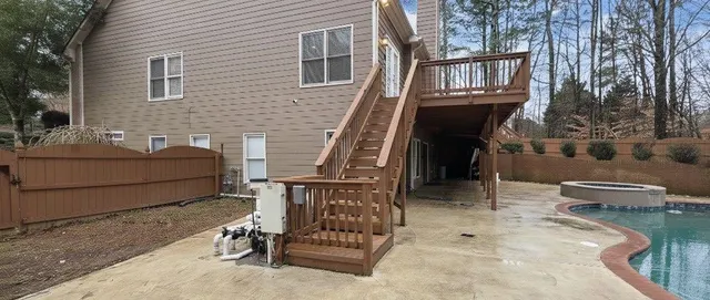 a house view with swimming pool in front of it