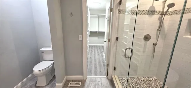 a bathroom with a toilet and shower
