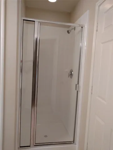 a bathroom with a glass shower door