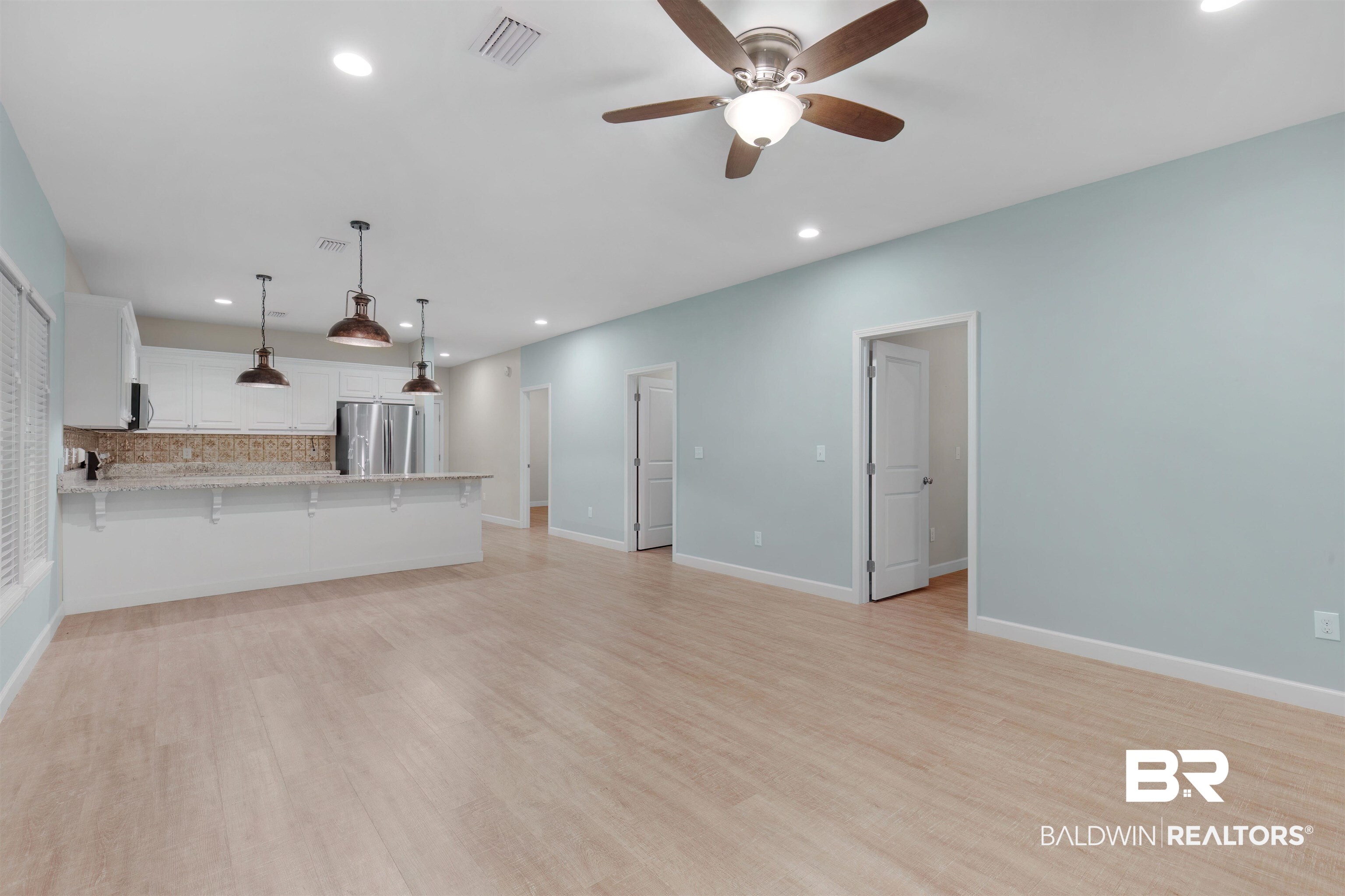 5625 Georgia Street Orange Beach, AL 36561 - Photo 5 of 30 Unfurnished living room with light wood-type flooring and ceiling fan