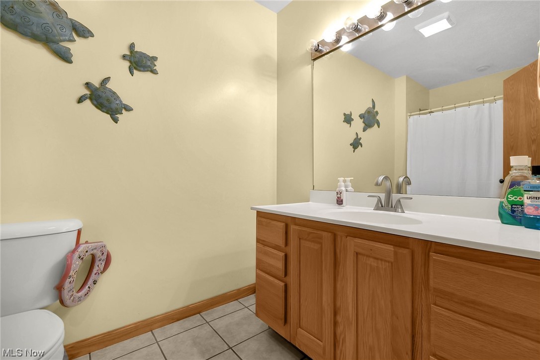4900 Ellerman Road Zanesville, OH 43701 - Photo 16 of 28 Bathroom featuring vanity, toilet, and tile flooring