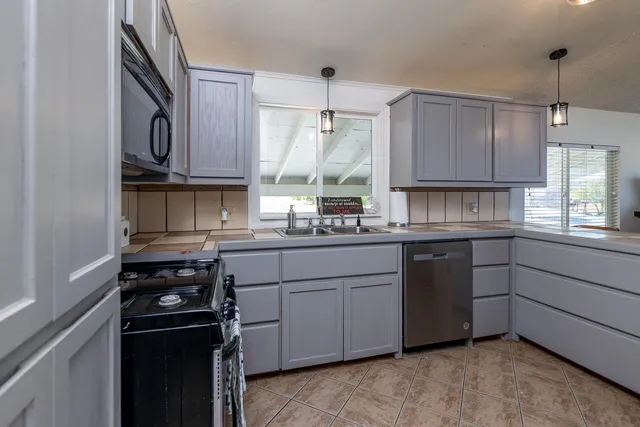 a kitchen with a sink stove and cabinets
