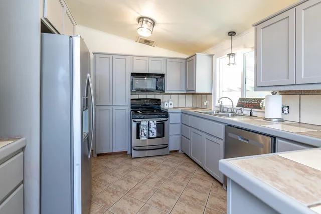 a kitchen with a sink stove and refrigerator