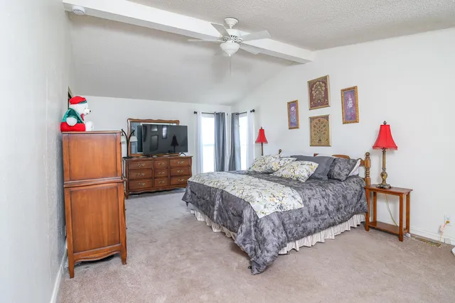 a bedroom with bed and window