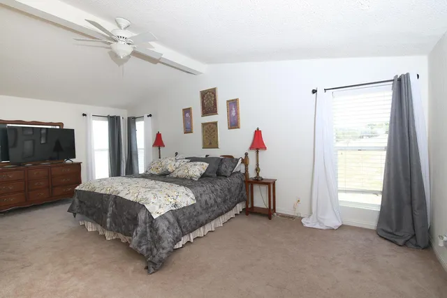 a bed room with a bed and a television