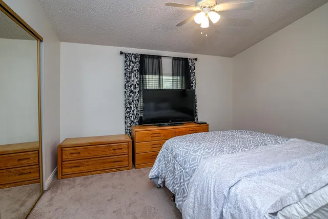 a bedroom with a bed and a chandelier