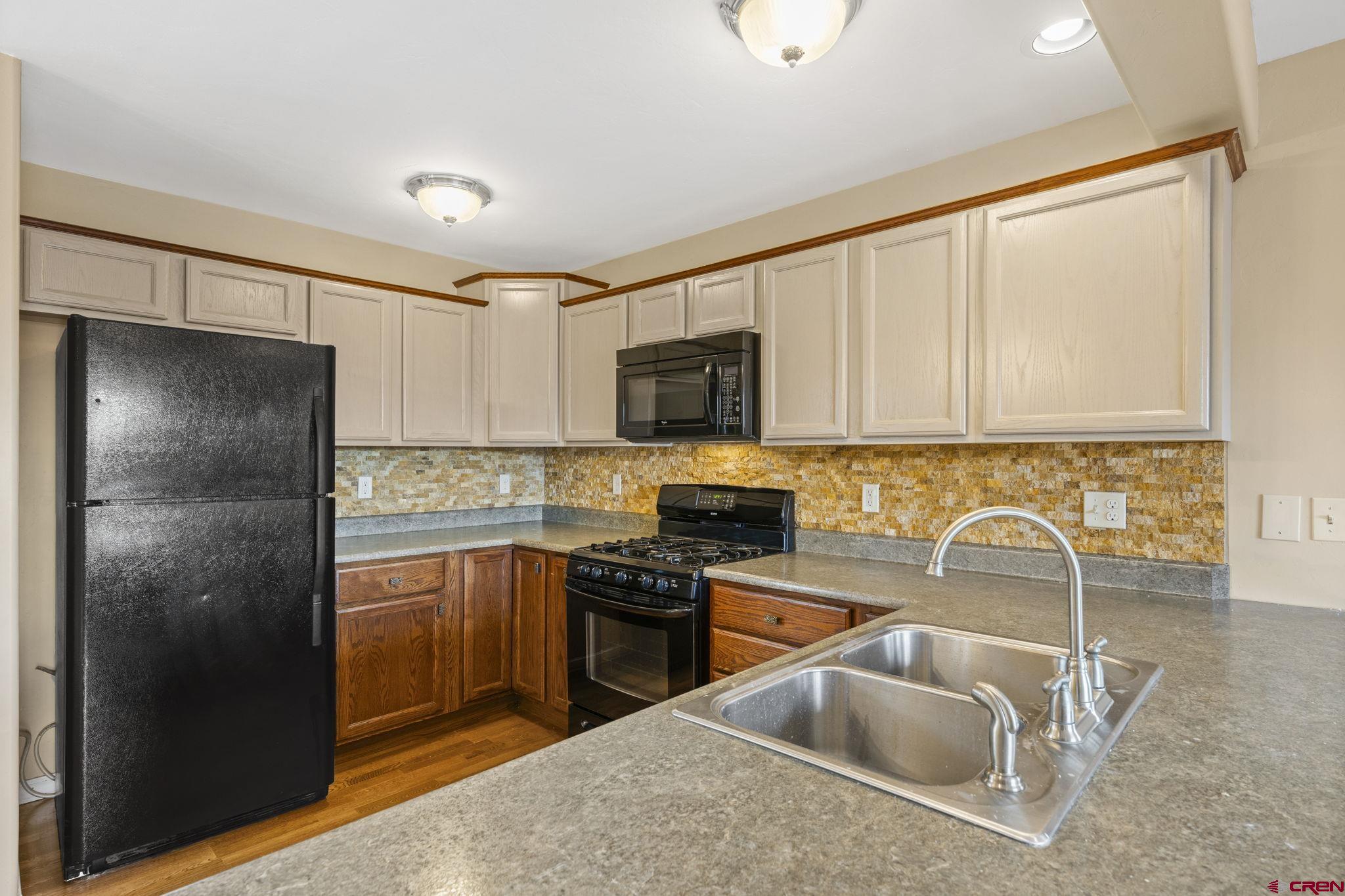 724 Jacobs Lane Bayfield, CO 81122 - Photo 11 of 33 a kitchen with granite countertop a refrigerator sink and stove