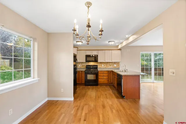 a view of a kitchen with a sink and wooden floor