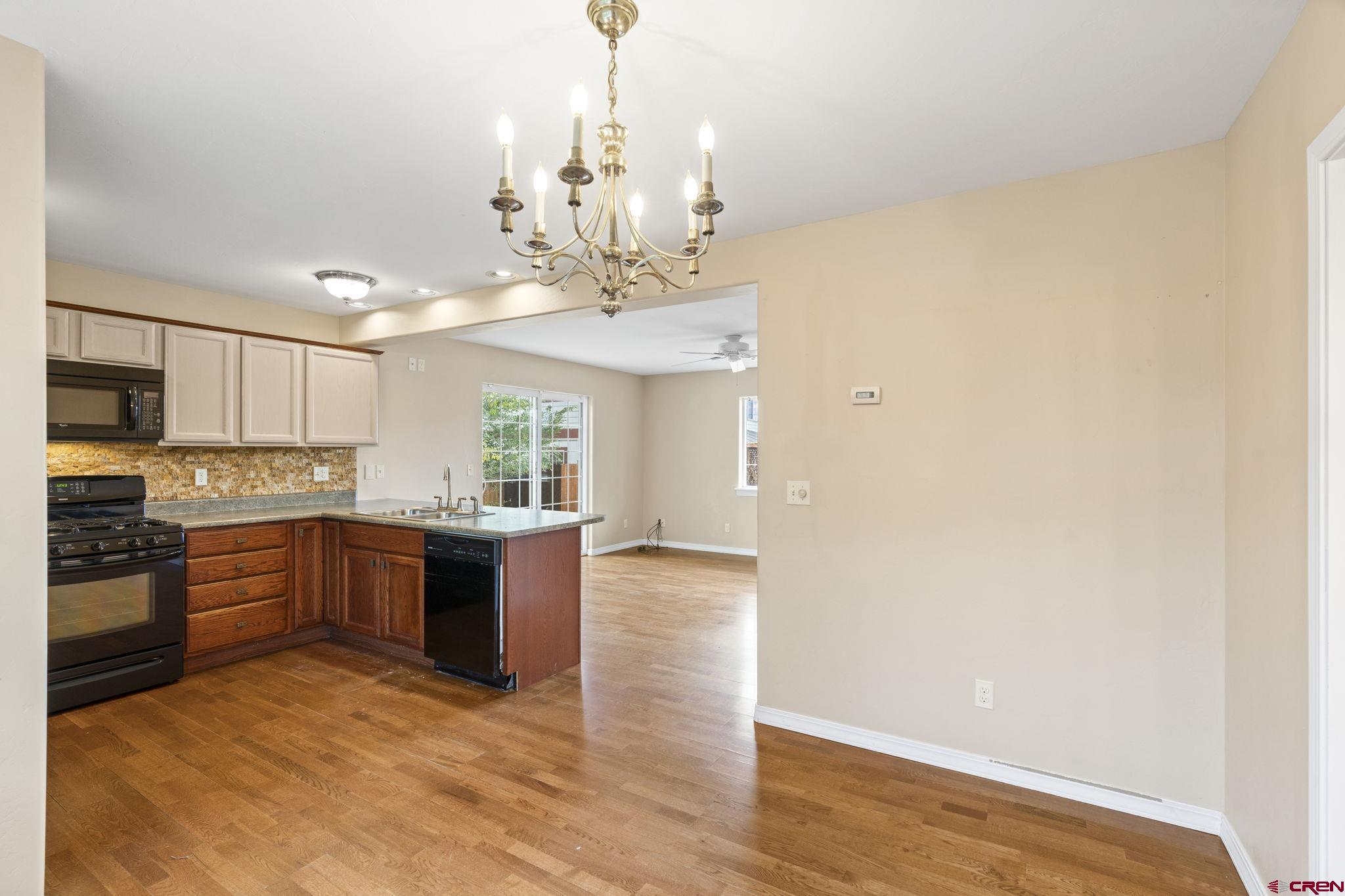 724 Jacobs Lane Bayfield, CO 81122 - Photo 14 of 33 a large kitchen with stainless steel appliances granite countertop a stove and cabinets with wooden floor