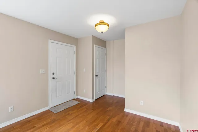 a view of an empty room and wooden floor