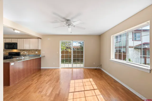 a view of a kitchen with a sink and a window