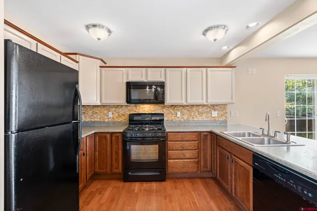 a kitchen with a sink stove and refrigerator